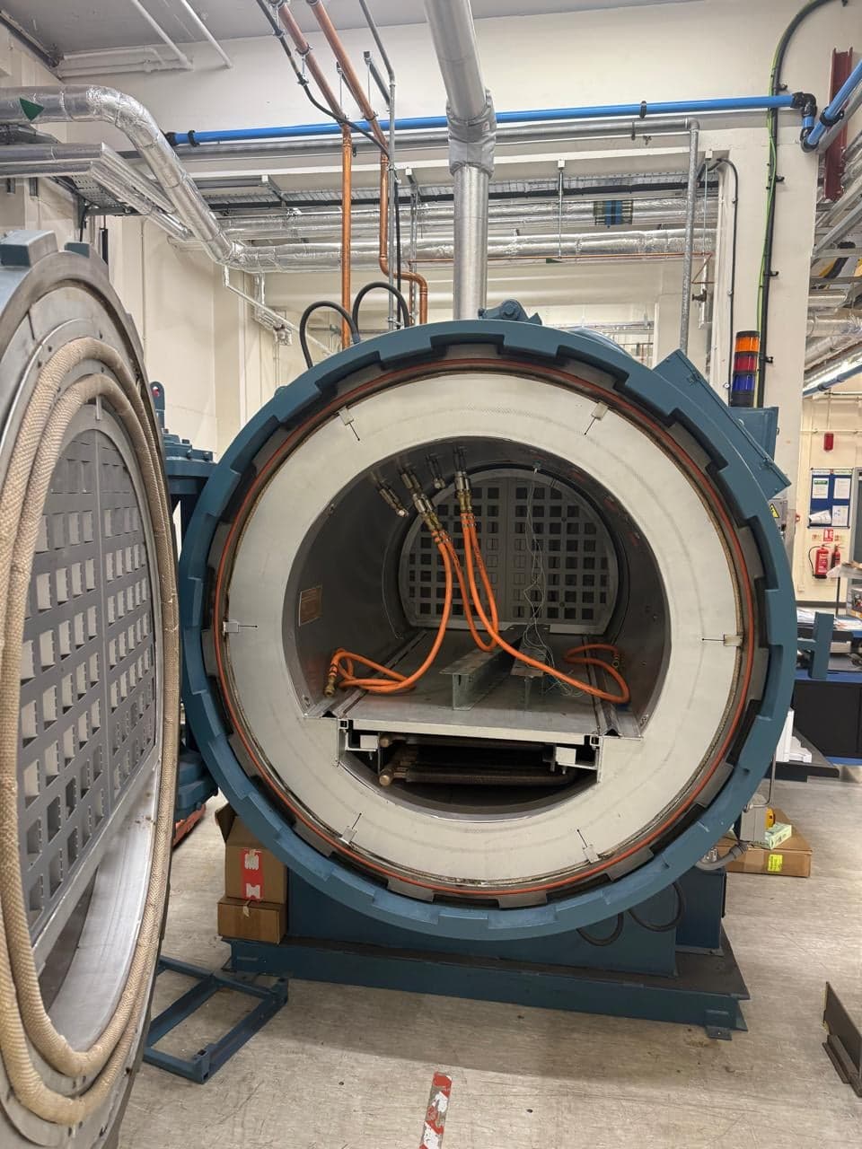 Open autoclave loaded with a composite panel on the rack before cure