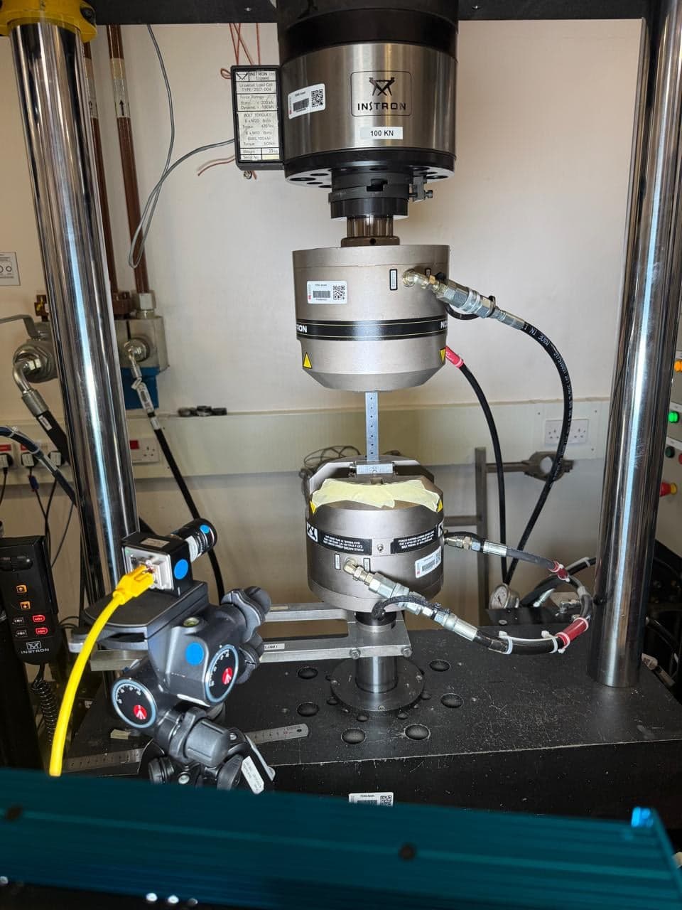 Instron 1342 test machine with hydraulic grips and the video gauge mounted on its tripod