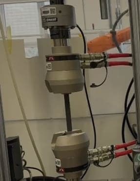 Composite coupon mounted in the test machine grips
